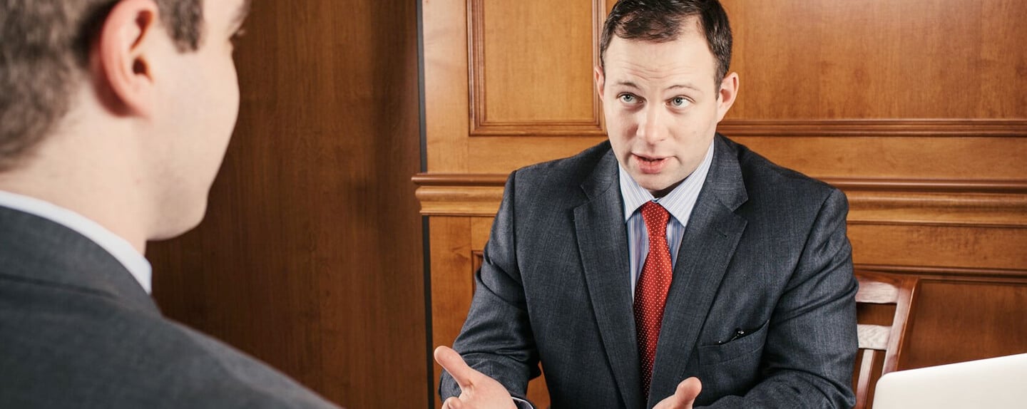 Attorney Mike Worgul talking to client in court room, How to Get Charges Dismissed at the Preliminary Hearing in Pennsylvania, what is a preliminary hearing